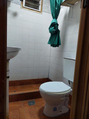 a bathroom with a toilet and a sink at rancho de los bellidos in Perico