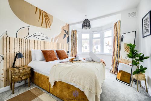 a bedroom with a large bed and a window at Coventry Stunning House, 3 double beds, Birmingham Airport NEC, Sleeps 7, by EMPOWER HOMES in Coventry