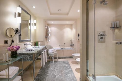 a bathroom with a sink and a shower and a toilet at Rocco Forte Hotel Amigo in Brussels