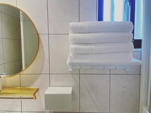 a stack of towels on a shelf in a bathroom at Zhu Shan Xian Ting in Jincheng