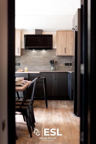 a kitchen with a table and chairs in a room at Central 5 Bedroom Townhouse perfectly located 2 mins walk from the Train Station in Chester