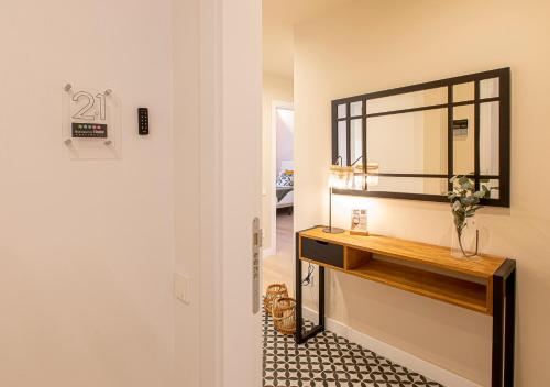 a bathroom with a vanity and a mirror on a wall at Barcelona Touch Apartments in Hospitalet de Llobregat