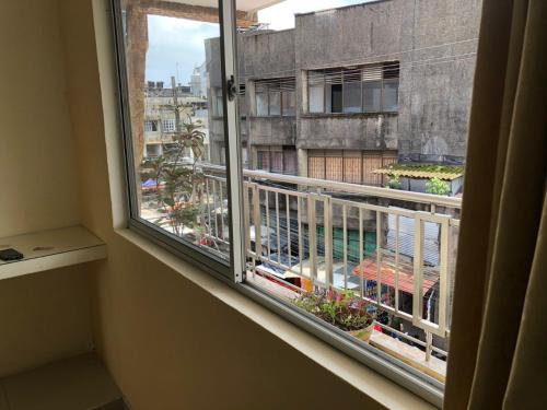 a window with a view of a building at Ayenda Hotel Ecosuite Quibdó in Quibdó