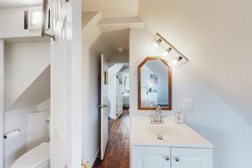 a white bathroom with a sink and a mirror at Town of Rehoboth 20 Delaware Ave in Rehoboth Beach