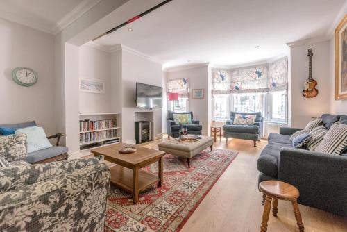 a living room with two couches and a table at The Pink House in Southwold in Southwold