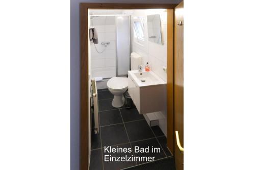 a bathroom with a toilet and a sink at Haus Magdalene in Bad Schwartau