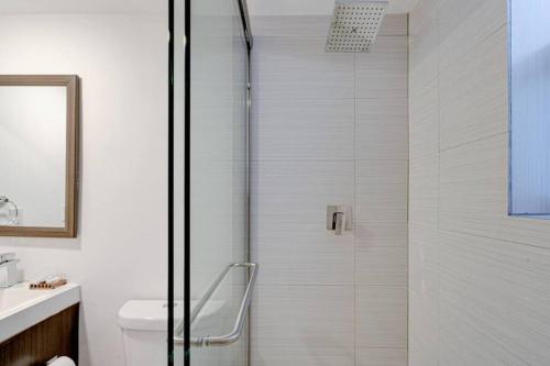 a shower with a glass door in a bathroom at Miami Vice - Wynwood Studios by Pattio in Miami