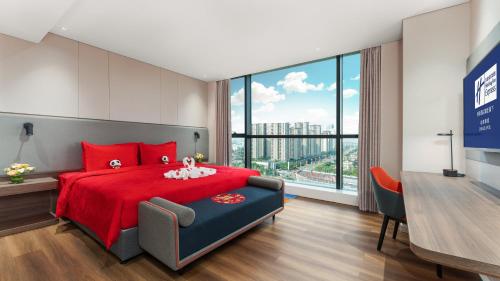 a bedroom with a red bed and a large window at Holiday Inn Express Chengdu Pidu, an IHG Hotel in Chengdu