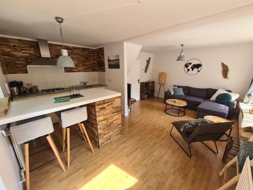 a living room and kitchen with a couch and a table at Have a nice stay! - North Sea Home in Noordwijk aan Zee