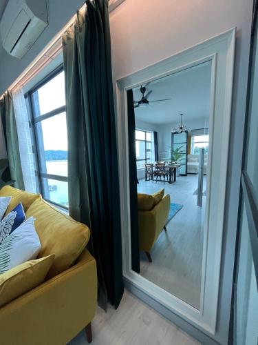 a mirror in a living room with a yellow couch at Mango House3-LuxurySweet I Biggest unit I infinity pool I Wifi-JQ in Kota Kinabalu