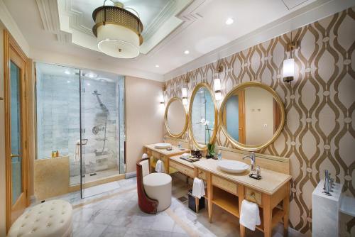 a bathroom with two sinks and two mirrors at InterContinental Grand Ho Tram in Ho Tram