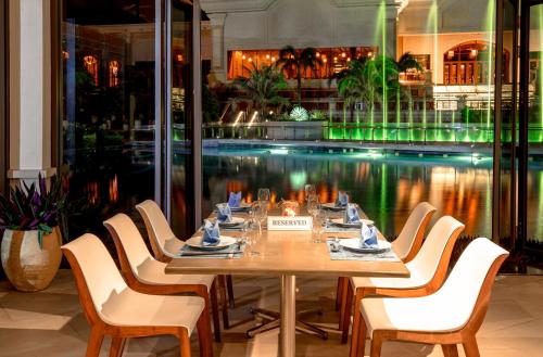 a table in a restaurant with a pool of water at InterContinental Grand Ho Tram in Ho Tram