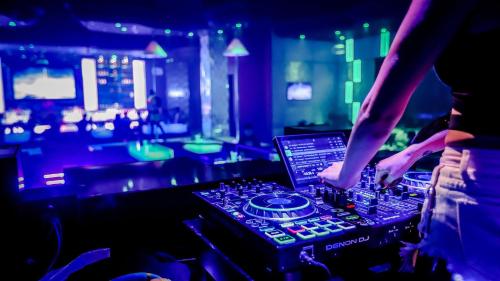 a person in a nightclub with a laptop on a mixing console at InterContinental Grand Ho Tram in Ho Tram