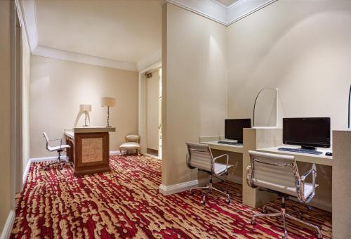 a room with two chairs and a desk with a computer at InterContinental Grand Ho Tram in Ho Tram