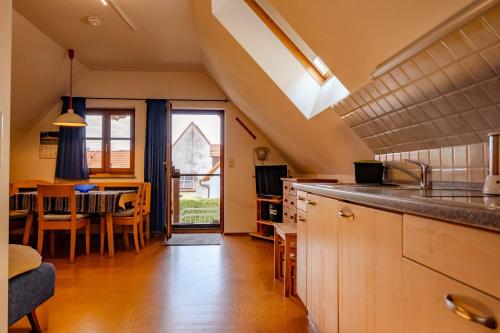 a kitchen with a counter and a dining room at BiolandHof Röttenbacher in Gunzenhausen