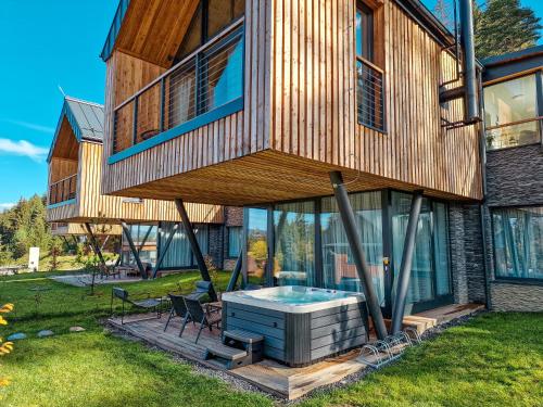 a tree house with a hot tub in the yard at Apartmán STRÖMY Demänovská dolina in Liptovský Mikuláš