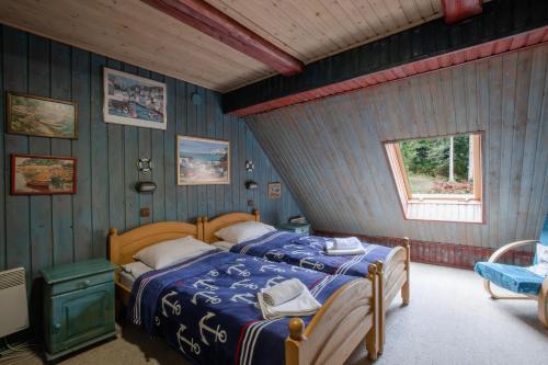 a bedroom with a bed in a room with blue walls at Маєток Ліс і Гори in Bukovel