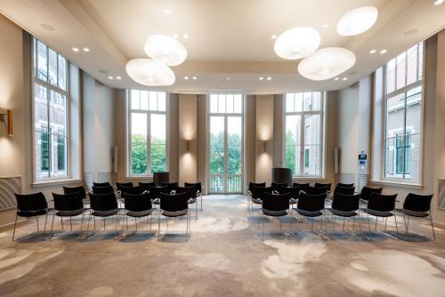 a conference room with black chairs and windows at Pillows Grand Boutique Hotel Maurits at the Park - Small Luxury Hotels in Amsterdam