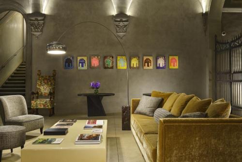a living room filled with furniture and decorations at Hotel Garibaldi Blu - WTB Hotels in Florence