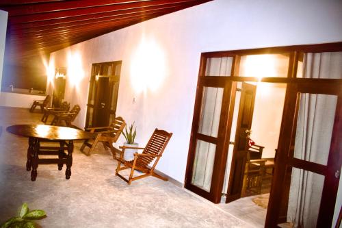 a room with a table and chairs and a room with a table and chairsktop at Emma's Sea View in Hiriketiya