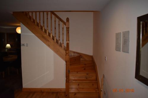 a wooden staircase in a room with a stair case at Erne River Lodge in Belturbet