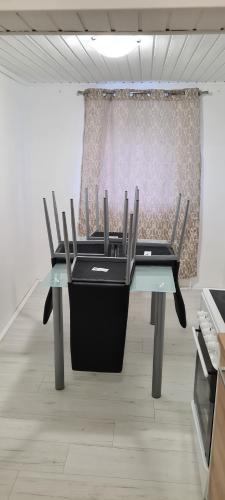 a table with four chairs in a room at SG Apartment in Freistadt