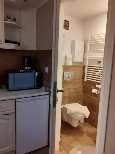 a small bathroom with a toilet and a sink at Beach House in Międzyzdroje