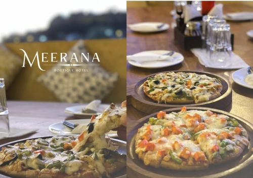 two pizzas on plates on a table with a pizza at Hotel Meerana in Jaisalmer