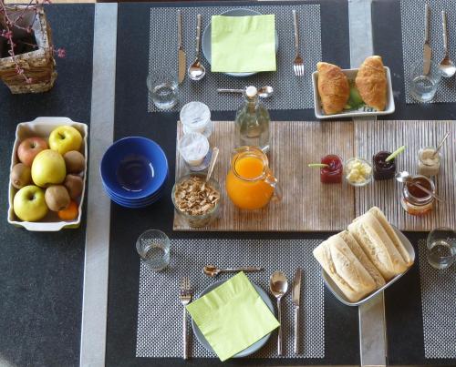 a table topped with plates of bread and fruit at Ca'Luna Guest House in Mondovì