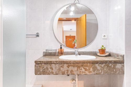 a bathroom with a sink and a mirror at Bellemar Apartment by Homie in Panasqueira