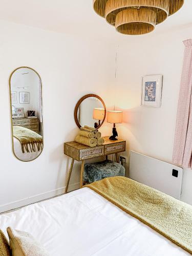 a bedroom with a bed and a mirror at This must be the place - Skye, Carbost in Carbost