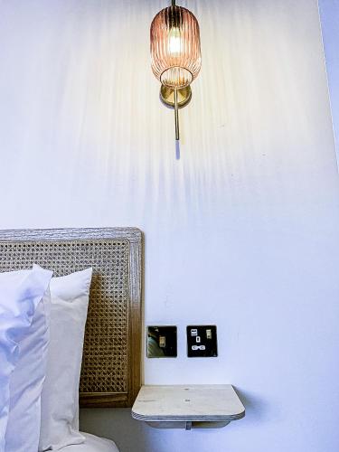 a room with a bed with a lamp and a table at This must be the place - Skye, Carbost in Carbost