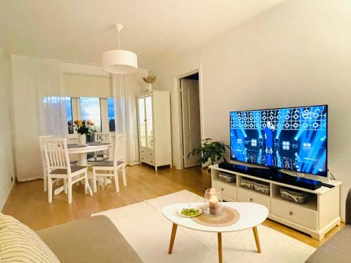a living room with a large flat screen tv at Keskuse apartment with a balcony in Haapsalu