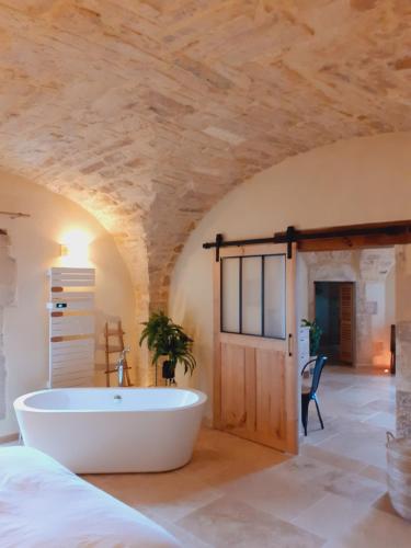 a bathroom with a large tub in a room at coeur de famille in Bessas