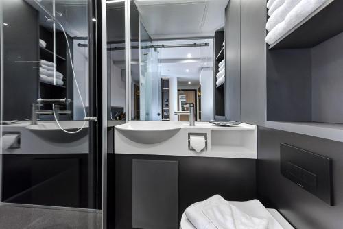 a bathroom with a sink and a mirror at The Z Hotel Strand in London