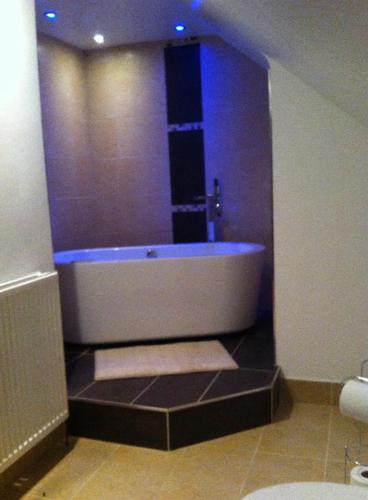 a bathroom with a bath tub with blue lights at Top floor in beautiful home in Radipole