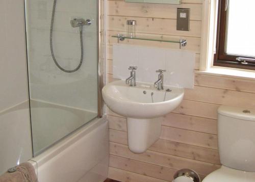 a bathroom with a sink and a shower at Wighill Manor Lodges in Newton Kyme