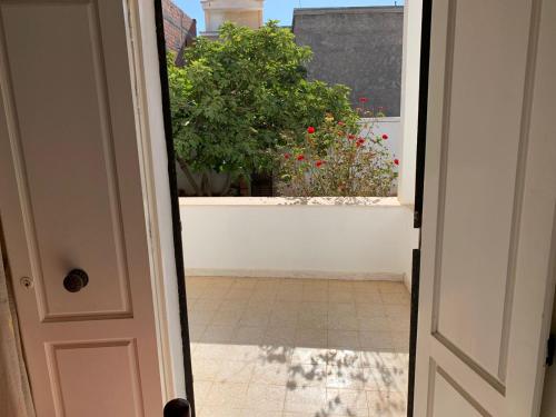 an open door with a view of a balcony with flowers at Mittelmeer Villa 