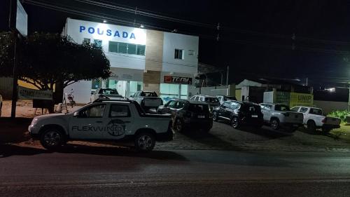 a group of vehicles parked in front of a porsche dealership at Pousada Chapada do Araripe in Araripina