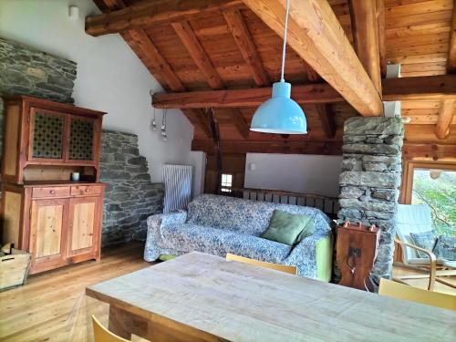 a living room with a couch and a table at Baita del noce in Mollia
