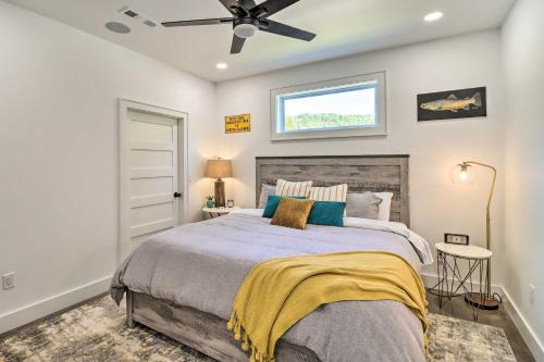 a bedroom with a bed and a ceiling fan at Modern Norfork House with Patio on White River! in Norfork