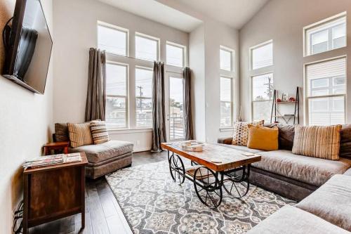 a living room with a couch and a table at Fam Friendly 5 Bed Home Blocks To Pearl/Riverwalk! in San Antonio