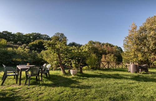 a table and chairs in the grass in a field at Casa di Monica in Torre San Severo