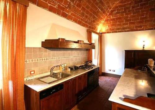 a kitchen with a sink and a counter top at Favolosa Villa in Toscana in Lucignano