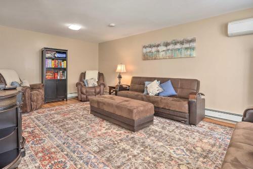 a living room with two couches and a rug at Tranquil Swansea Retreat with Fire Pit and Grill! in Swansea