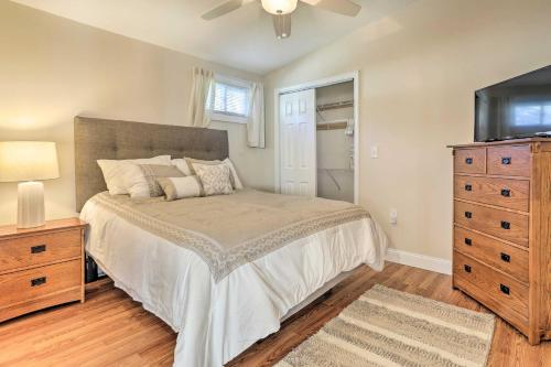 a bedroom with a bed and a dresser and a television at Tranquil Swansea Retreat with Fire Pit and Grill! in Swansea