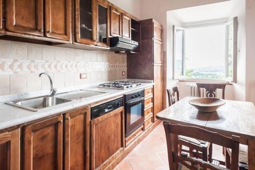 a kitchen with a sink and a stove at Favolosa Villa in Toscana in Lucignano