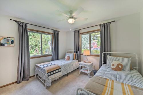 a bedroom with two beds and a window at Airy Cottage Close to Rock Lake with Fire Pit! in Lake Mills