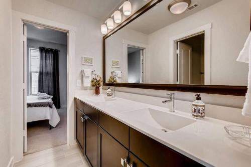 a bathroom with a sink and a large mirror at Fam Friendly 5 Bed Home Blocks To Pearl/Riverwalk! in San Antonio