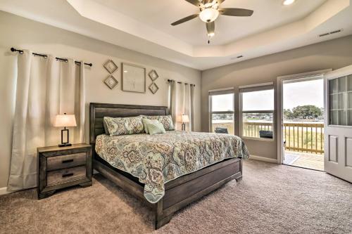 a bedroom with a bed and a balcony at Waterfront Paradise with Deck about half Mi to Beach in North Camellia Acres